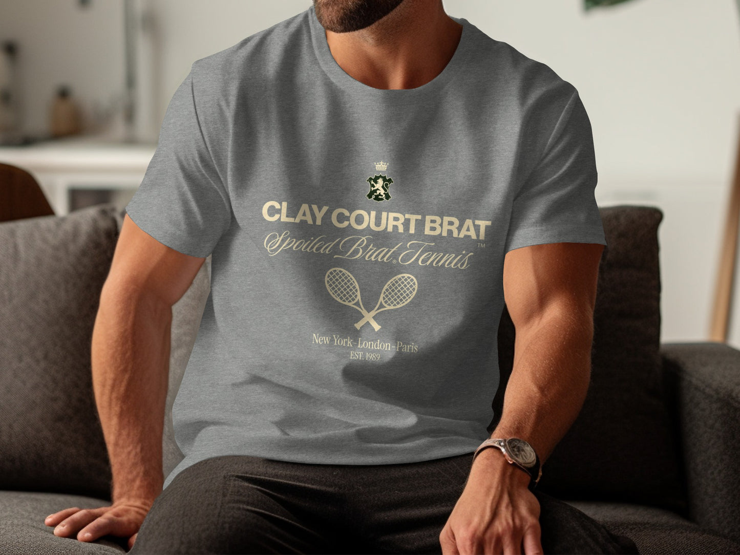 Gray t-shirt with "Clay Court Brat Spoiled Brat Tennis" text and tennis rackets.