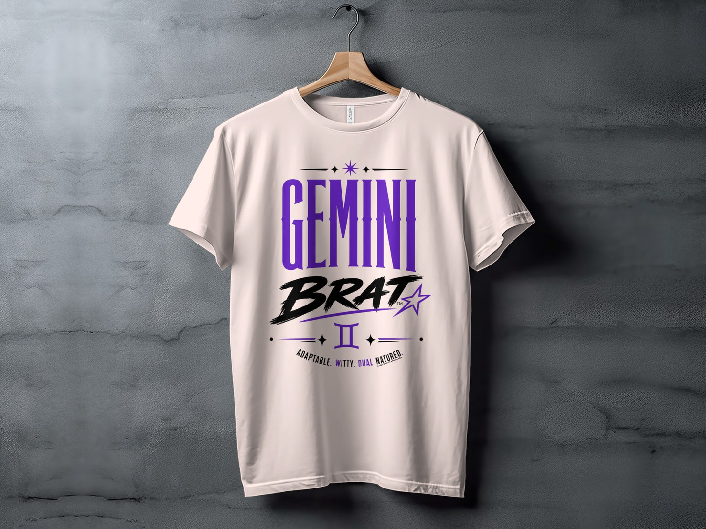 White t-shirt with "GEMINI BRAT" text in purple and black, zodiac symbol, and descriptive words.
