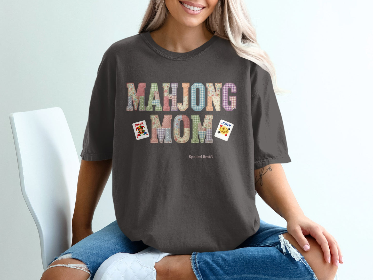 Dark t-shirt with "Mahjong Mom" text and two joker playing cards.