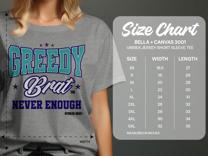 Grey t-shirt with text "Greedy Brat Never Enough" and a Bella+Canvas 3001 size chart.