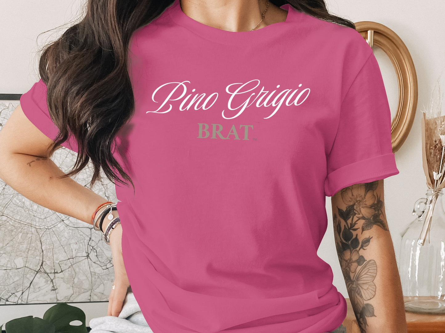 Pink t-shirt with "Pino Grigio BRAT" text in white and gray.