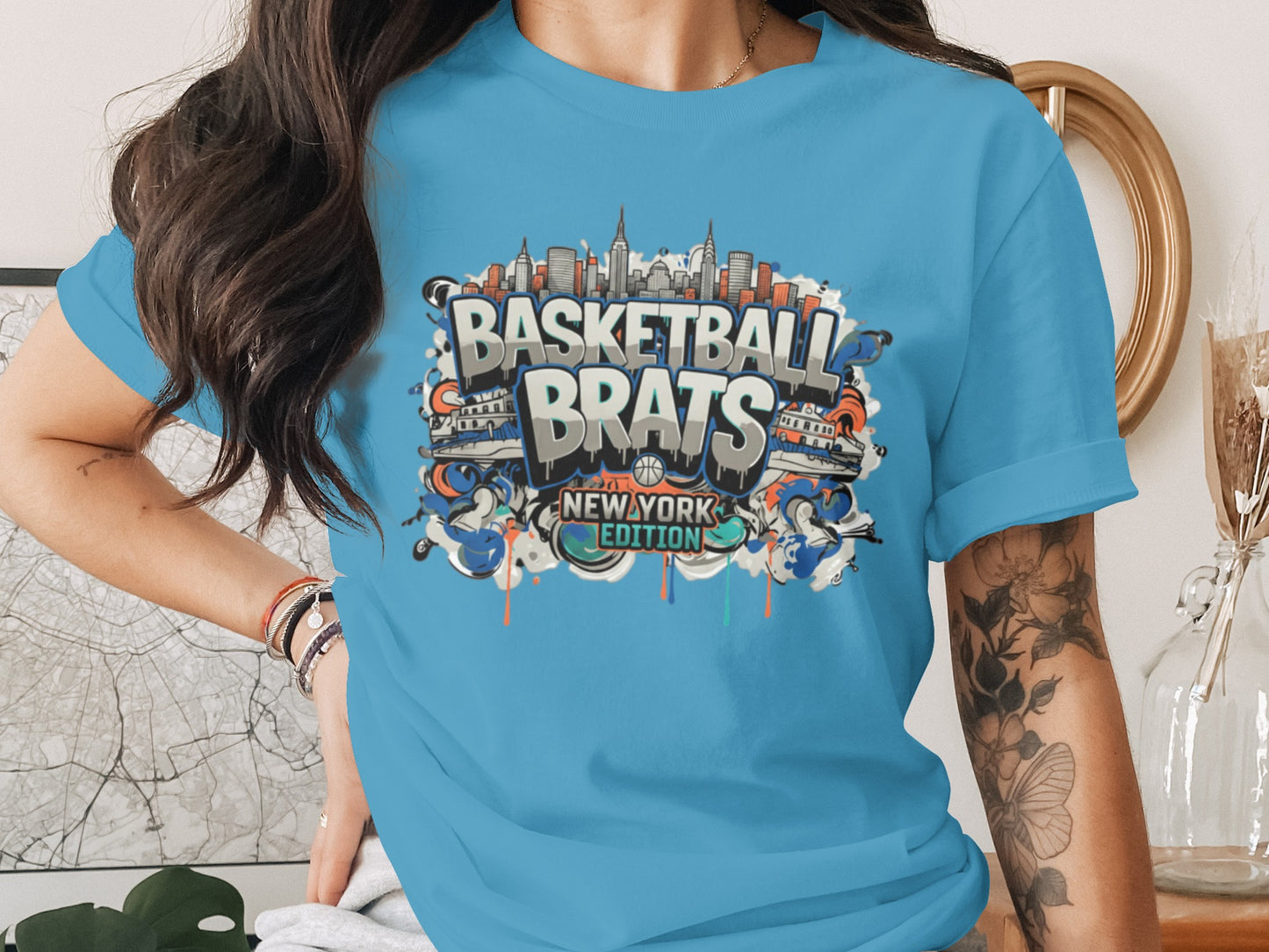 Blue t-shirt with "Basketball Brats New York Edition" graphic featuring city skyline.