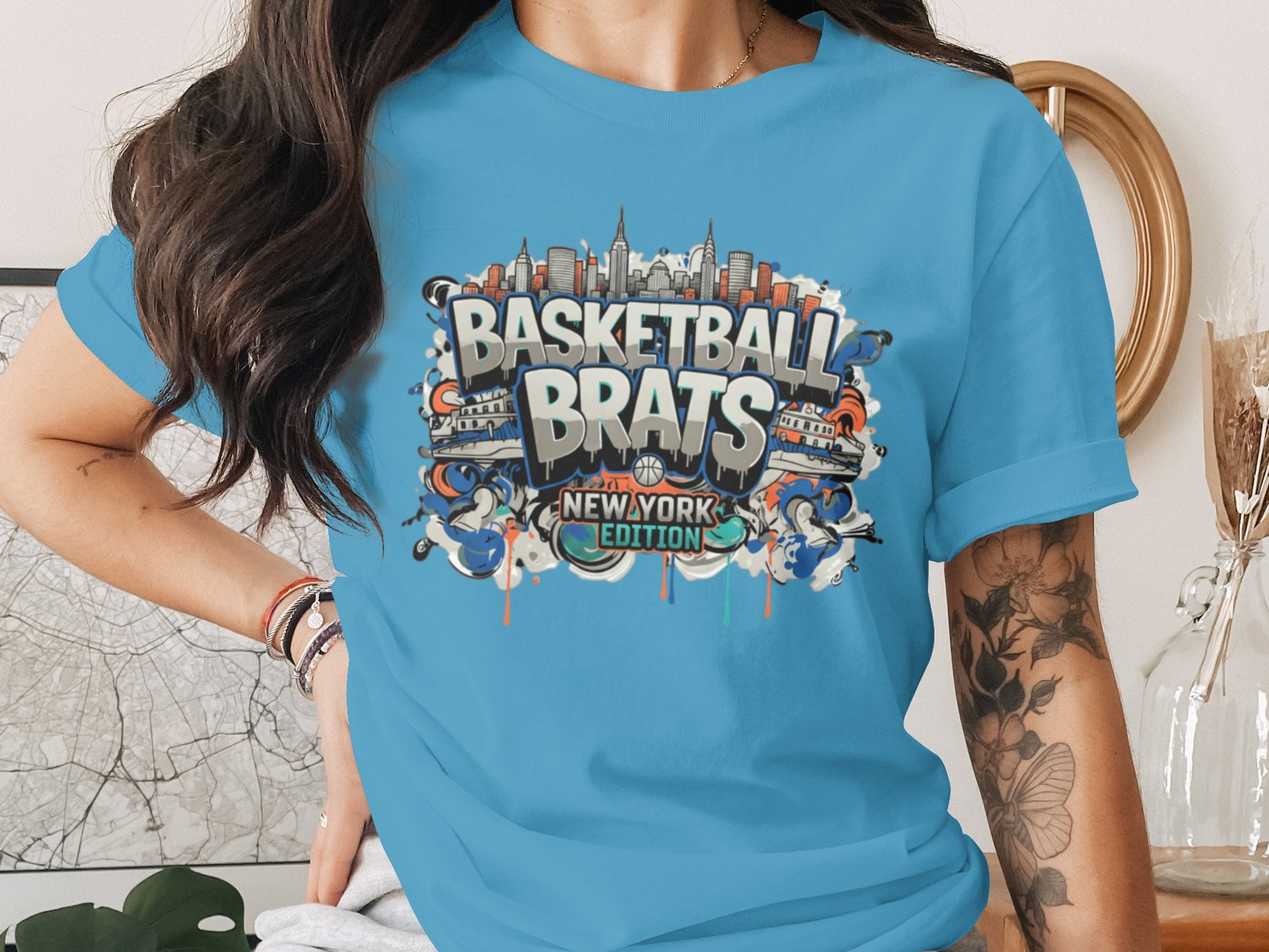 Blue t-shirt with "Basketball Brats New York Edition" graphic featuring city skyline.