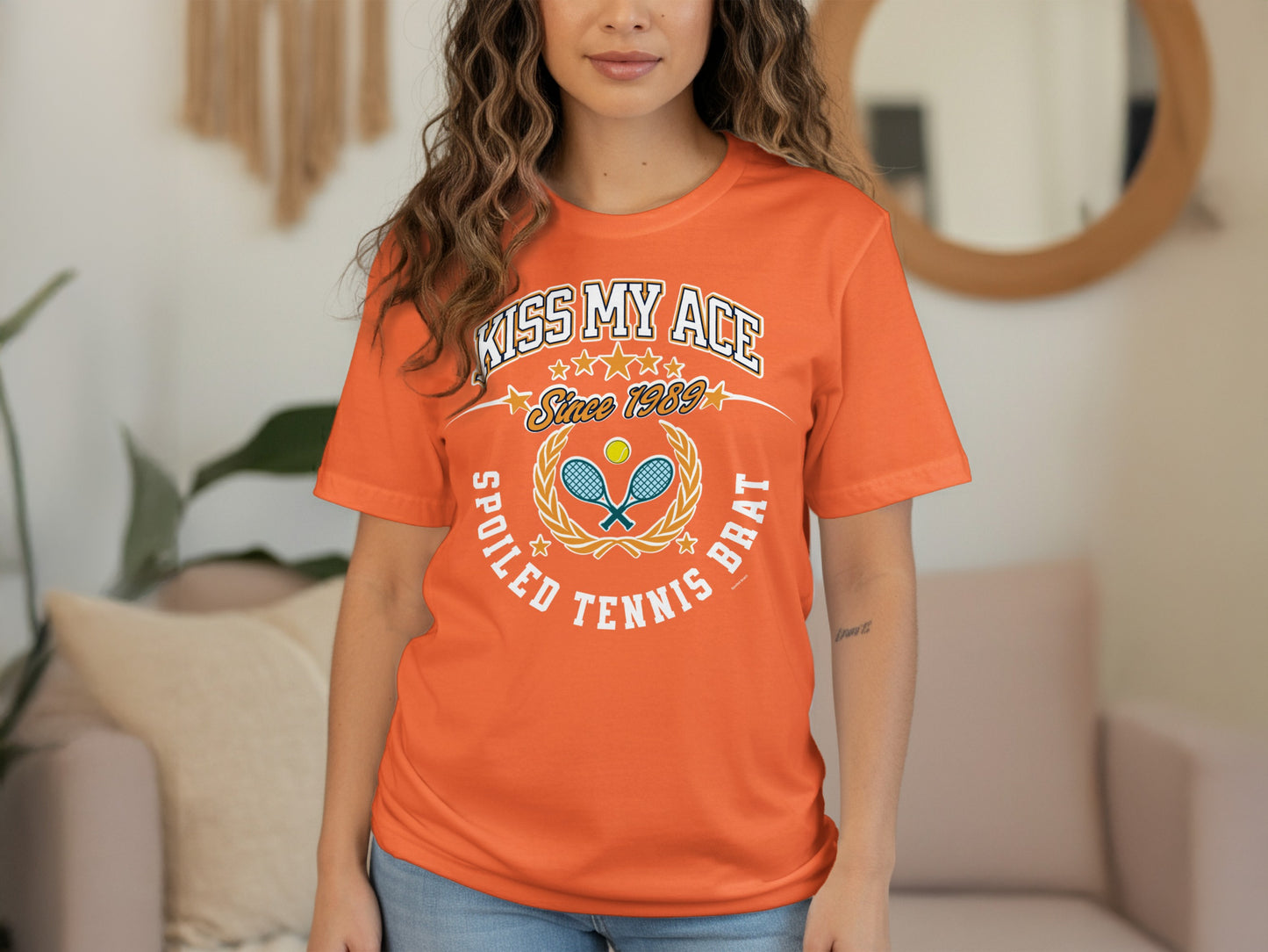 Orange t-shirt with "KISS MY ACE SINCE 1989 SPOILED TENNIS BRAT" text and tennis graphics.
