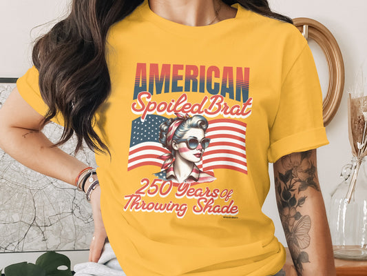 Yellow t-shirt with American flag and woman saying "250 Years of Throwing Shade".