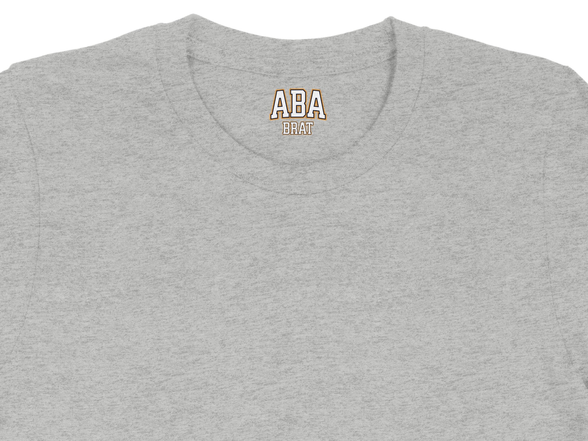 Grey t-shirt with "ABA BRAT" text on the collar.