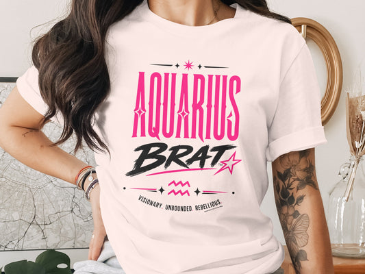 White t-shirt with "AQUARIUS BRAT" text, zodiac symbol, and descriptive words.
