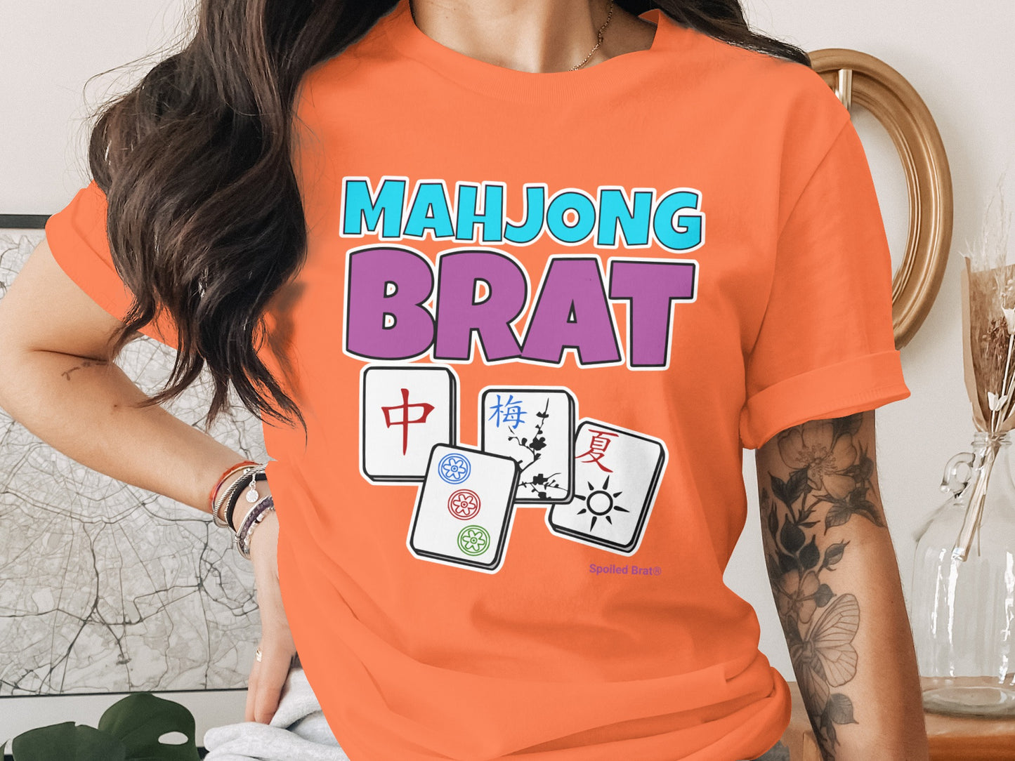 Orange t-shirt with "MAHJONG BRAT" text and four mahjong tiles.