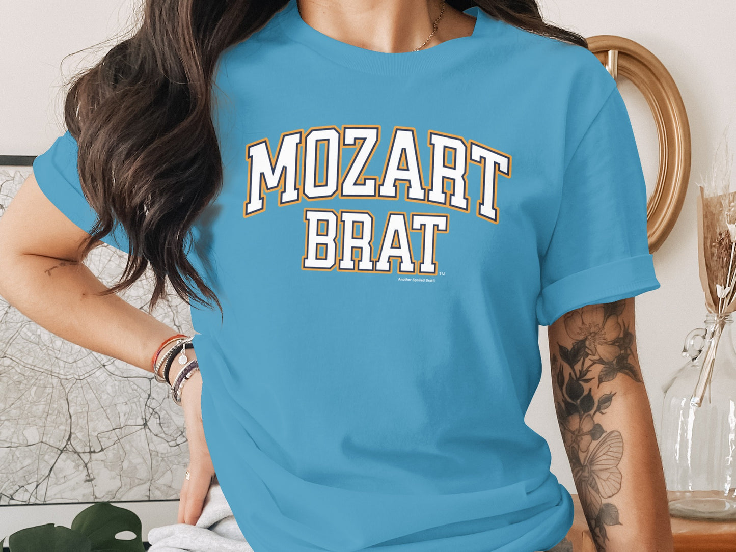 Light blue t-shirt with "MOZART BRAT" text in collegiate style lettering