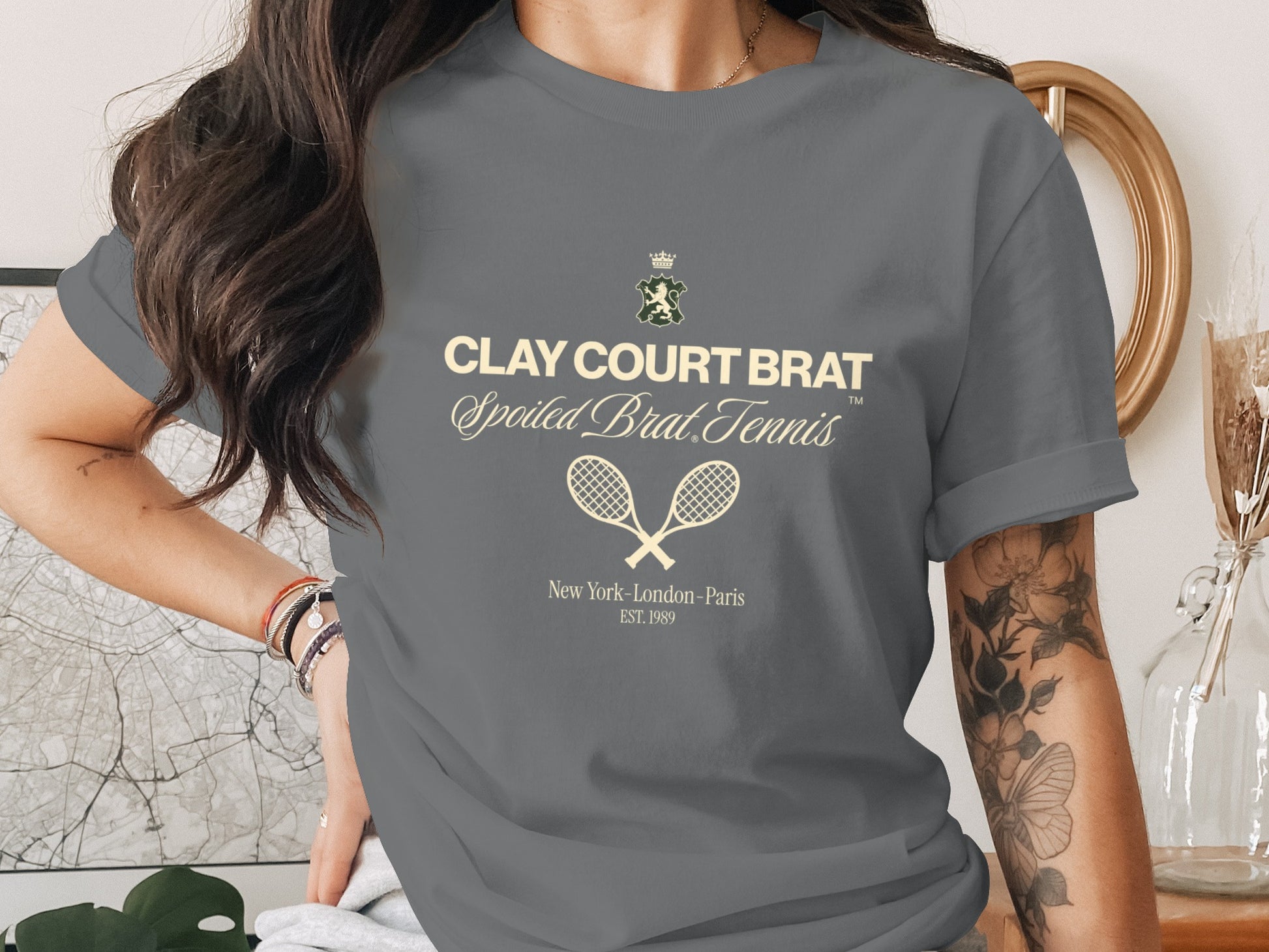 Gray t-shirt with "CLAY COURT BRAT Spoiled Brat Tennis" and tennis rackets.