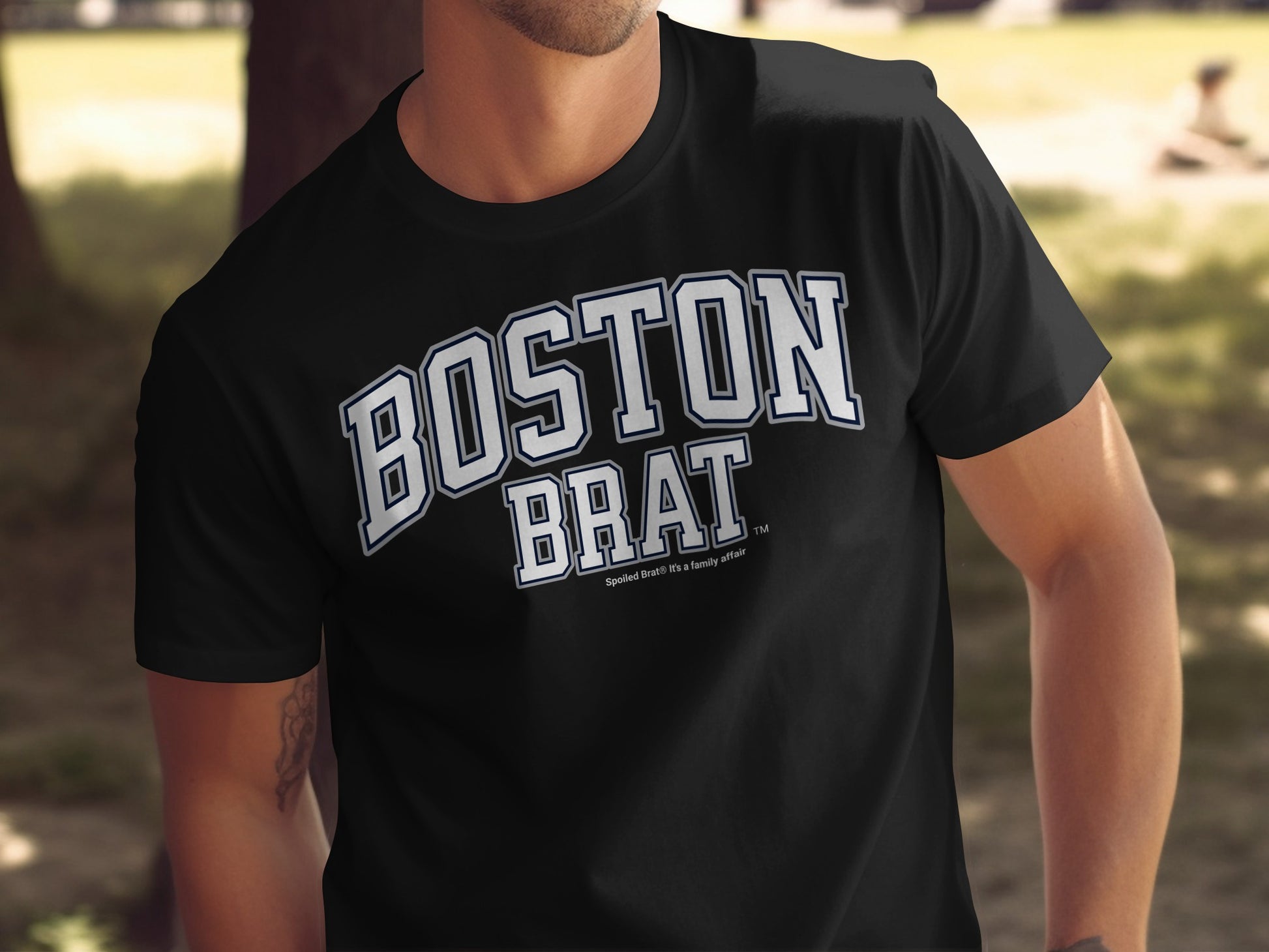 Black t-shirt with white text "BOSTON BRAT" and smaller text "Spoiled Brats. It's a family affair."