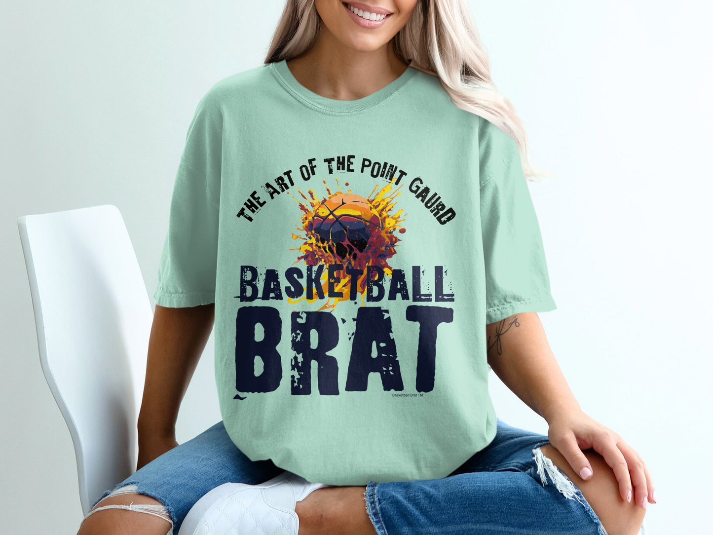 Light teal t-shirt with "Basketball Brat" graphic in bold letters.