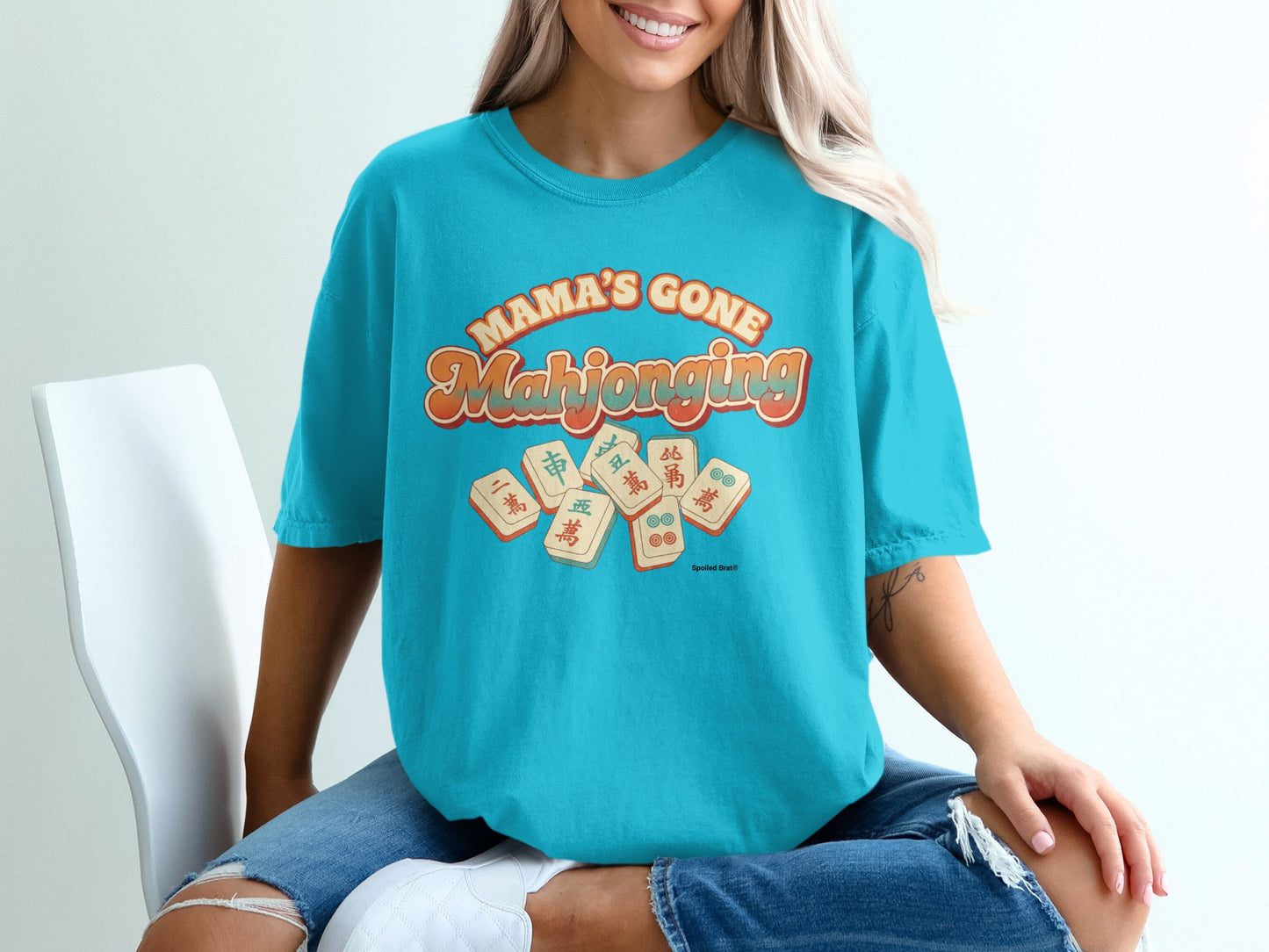 Turquoise t-shirt with "Mama's Gone Mahjong" in retro lettering.
