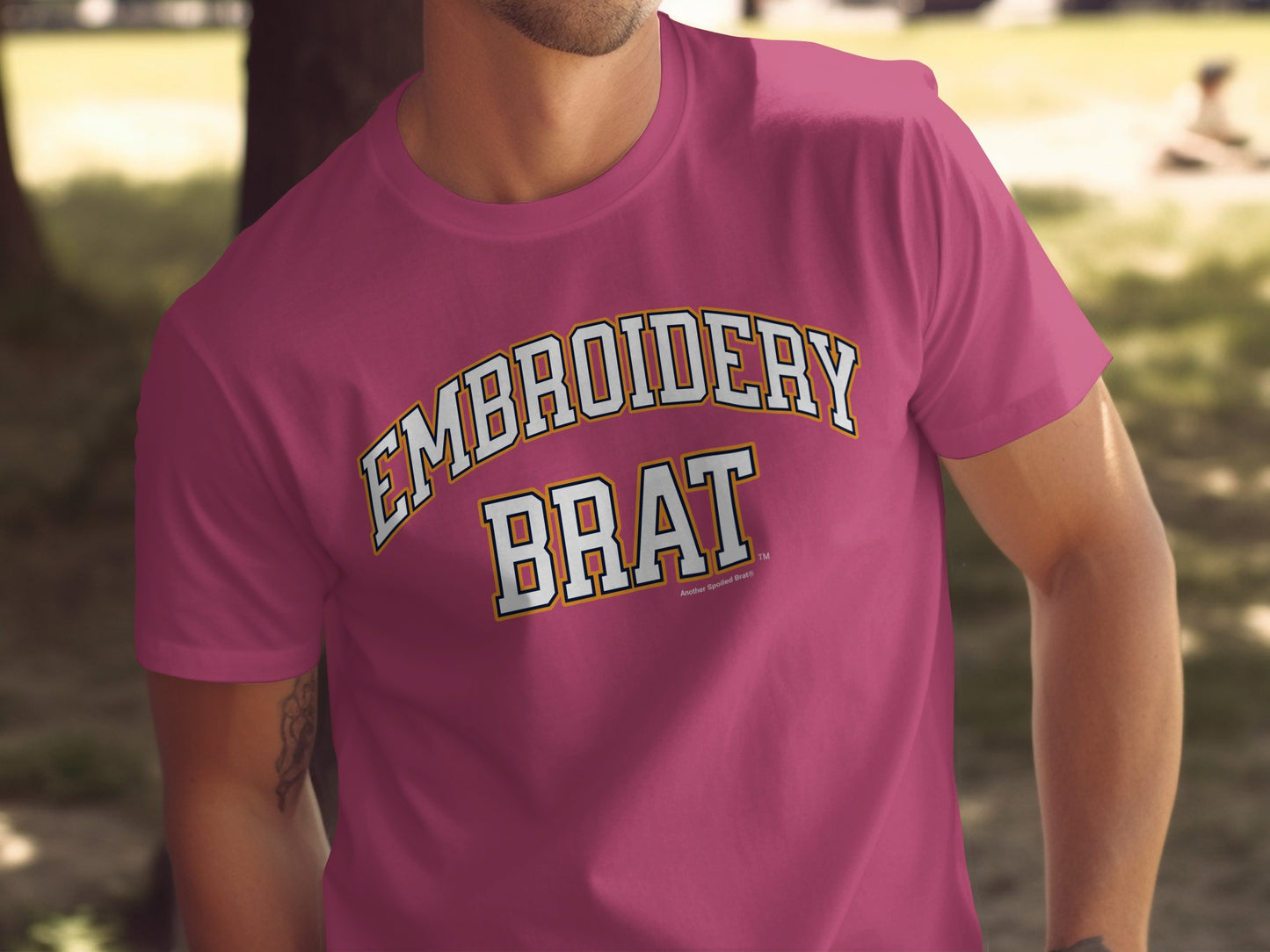 Maroon t-shirt with embroidered "EMBROIDERY BRAT" text.