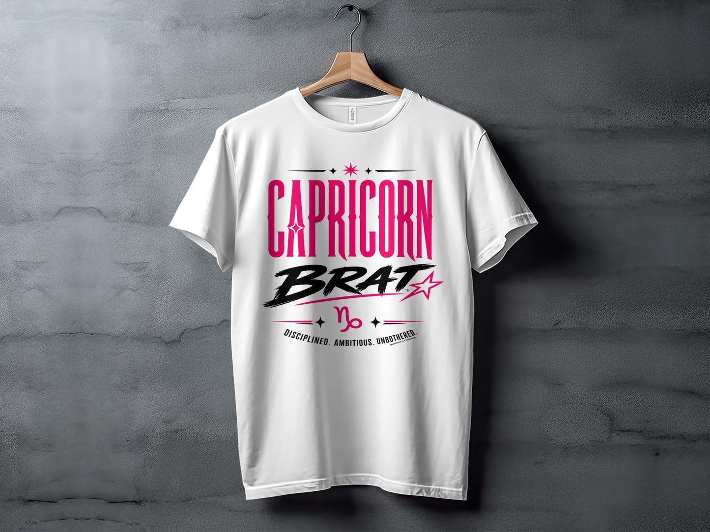 White t-shirt with "Capricorn BRAT" text, Capricorn symbol, and "Disciplined. Ambitious. Unbothered."