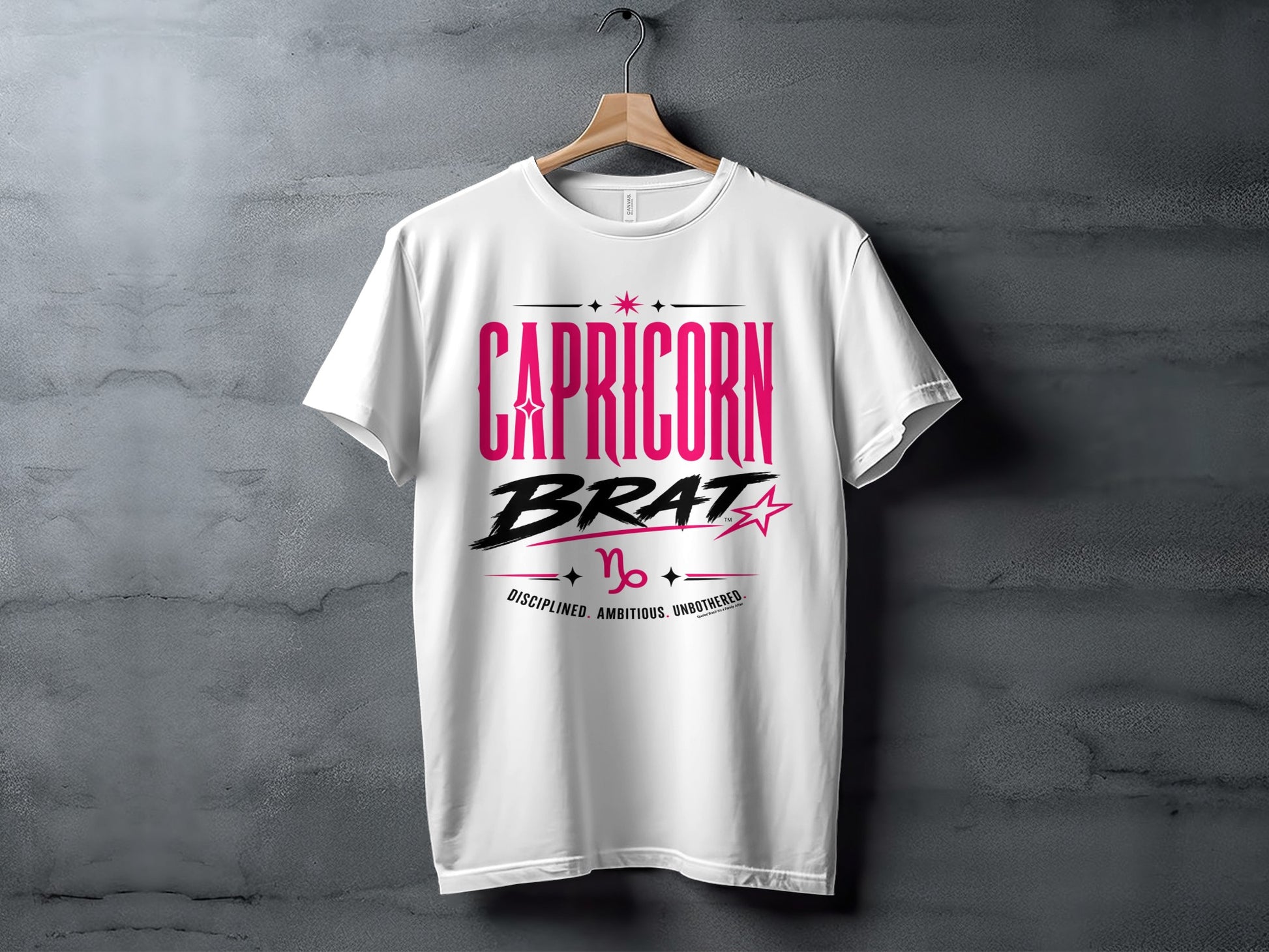 White t-shirt with "Capricorn BRAT" text, Capricorn symbol, and "Disciplined. Ambitious. Unbothered."