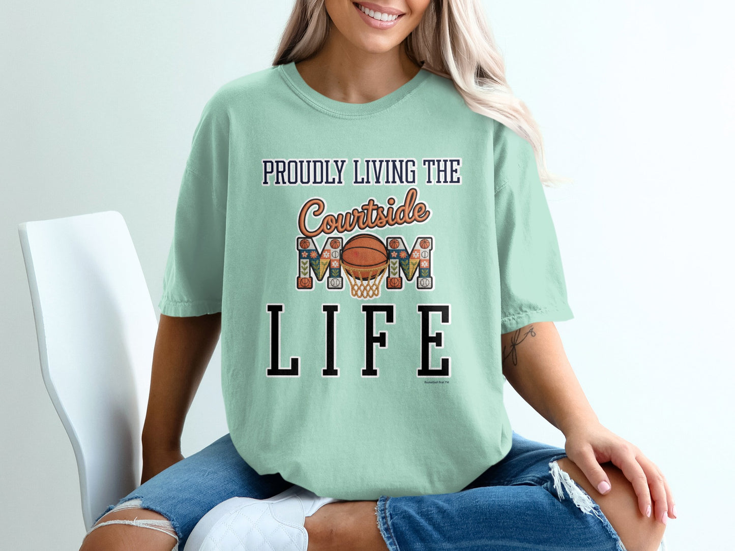 Shirt with text "Proudly Living the Courtside Mom Life" and basketball graphic.