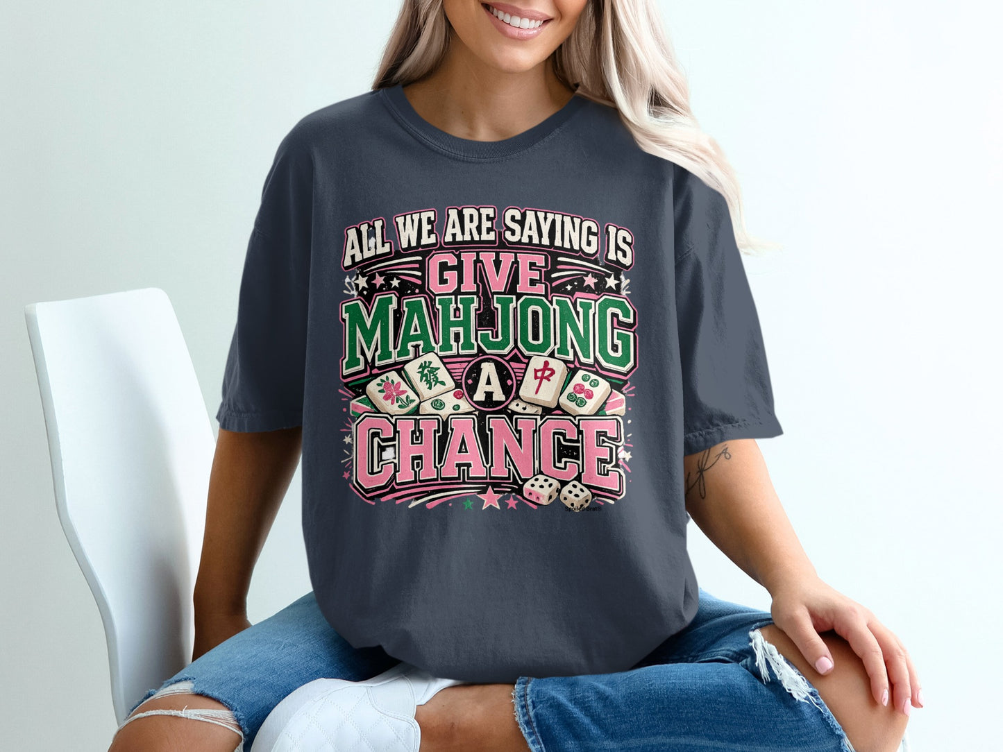 T-shirt with text "All we are saying is give Mahjong a chance" and mahjong tiles.