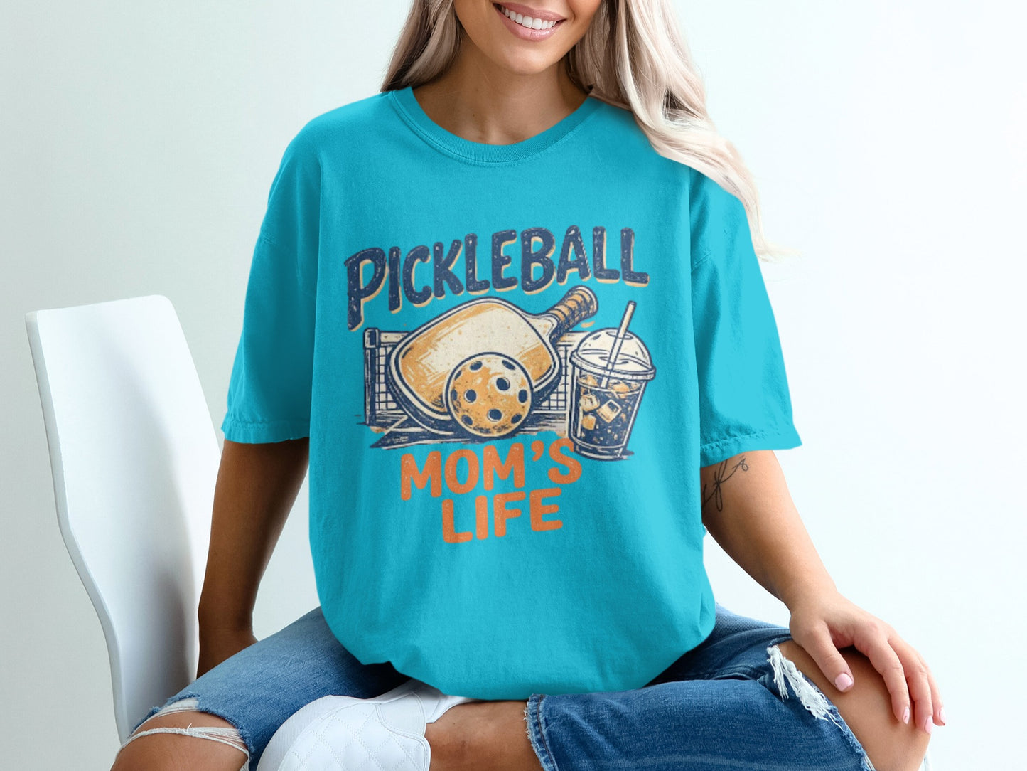 Turquoise t-shirt with "Pickleball Mom's Life" graphic, featuring a pickleball paddle and drink.