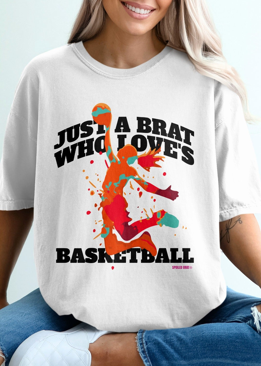 White t-shirt with colorful basketball player graphic and text.