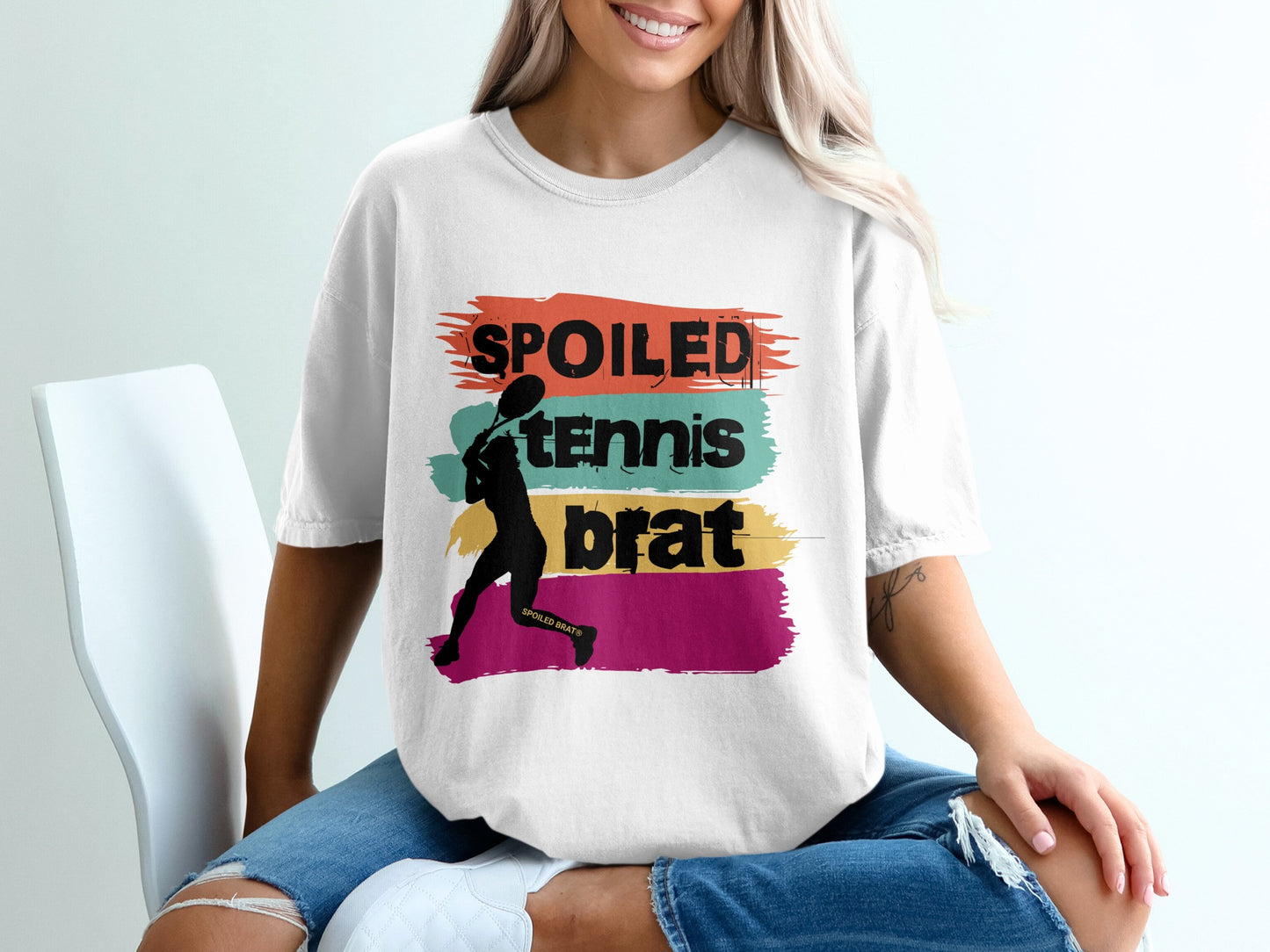 White t-shirt with "Spoiled Tennis Brat" text and tennis player silhouette.
