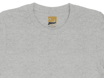 Grey t-shirt with "Scorpio Brat" slogan and descriptive words on the neck tag.