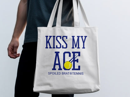 White canvas tote bag with "KISS MY ACE" and tennis ball graphic.