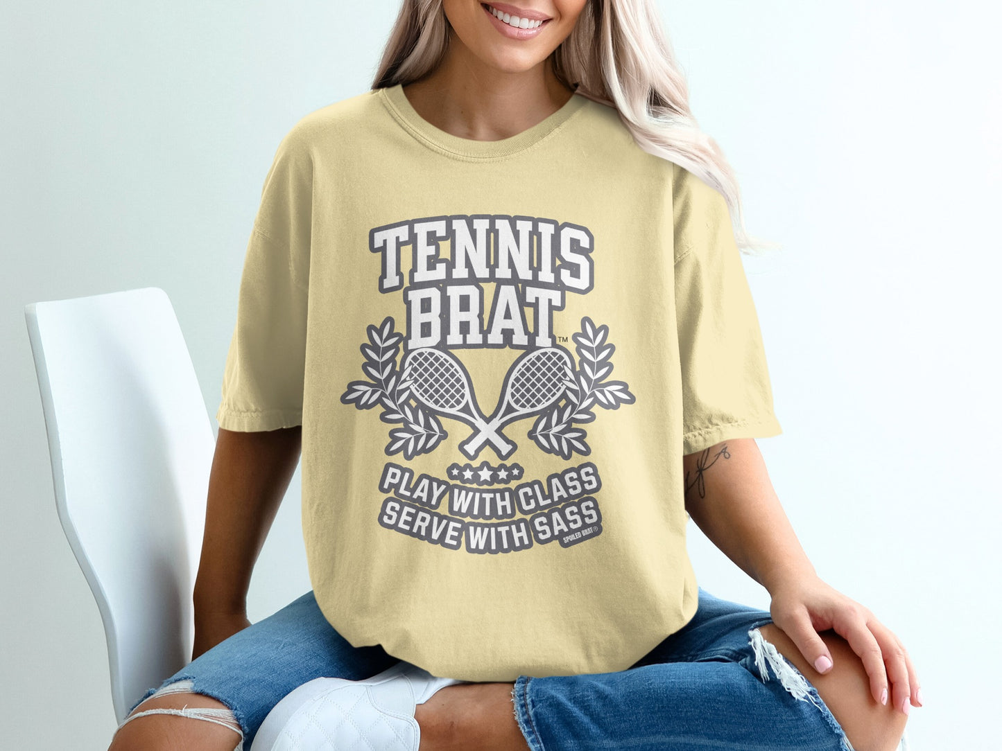 T-shirt with "TENNIS BRAT" and crossed rackets graphic.