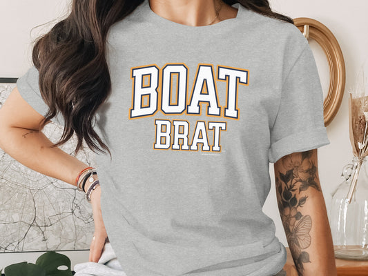 Grey t-shirt with "BOAT BRAT" in collegiate style lettering.