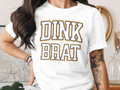 White t-shirt with "DINK BRAT" text in collegiate font.