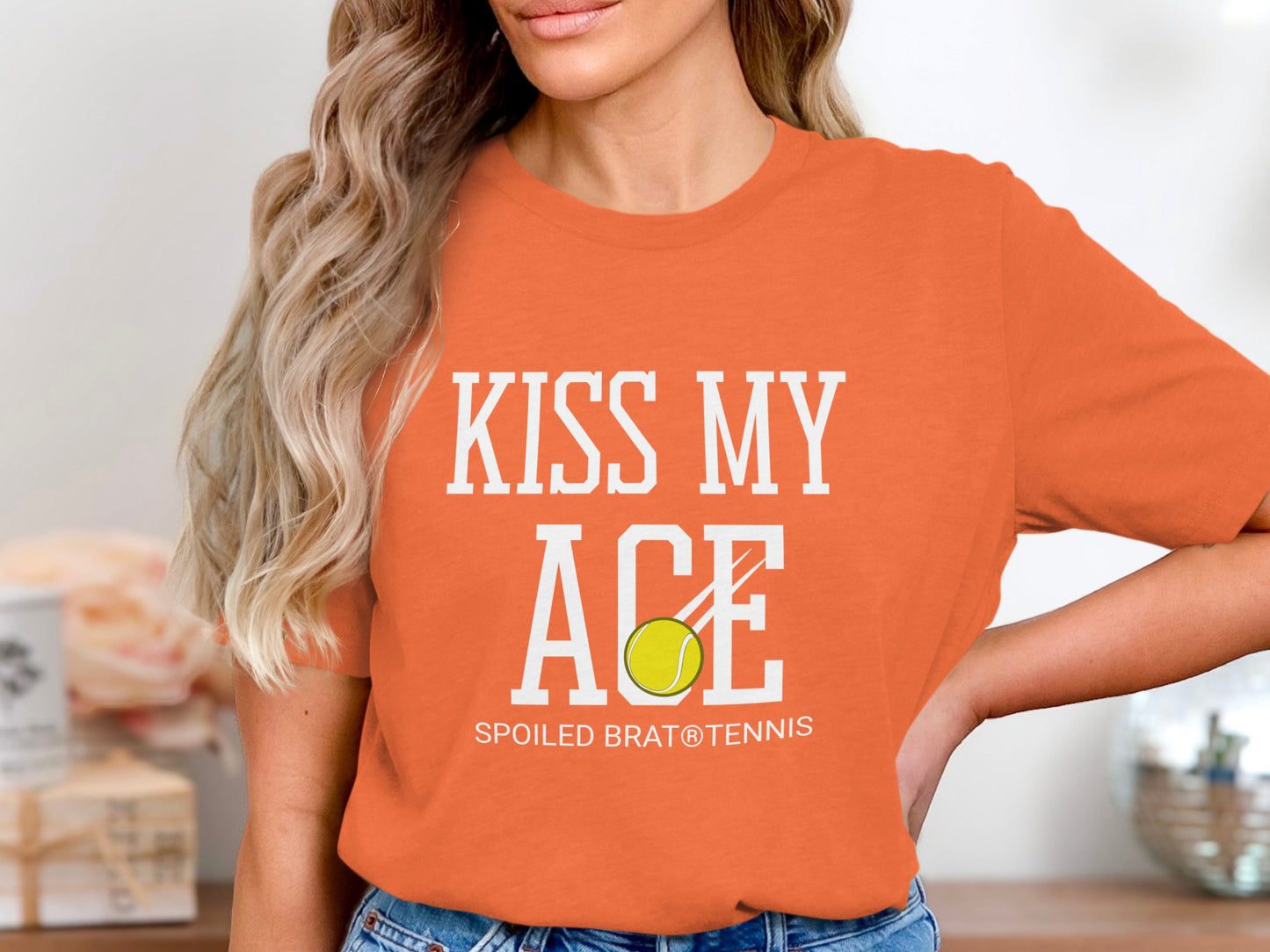 Orange t-shirt with "KISS MY ACE" and tennis ball graphic.