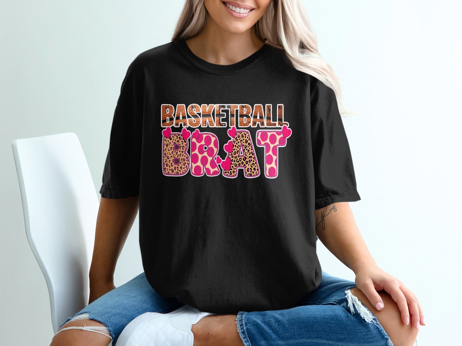 Black t-shirt with "BASKETBALL BRAT" in pink hearts and leopard print.