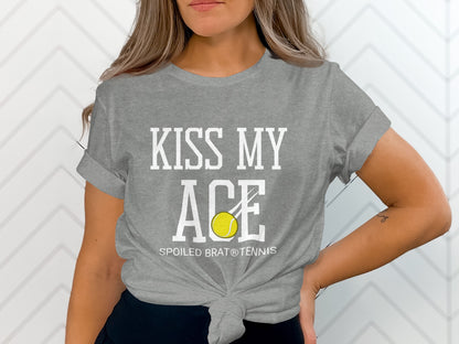 Gray t-shirt with "KISS MY ACE" and a tennis ball, "SPOILED BRAT® TENNIS" below.