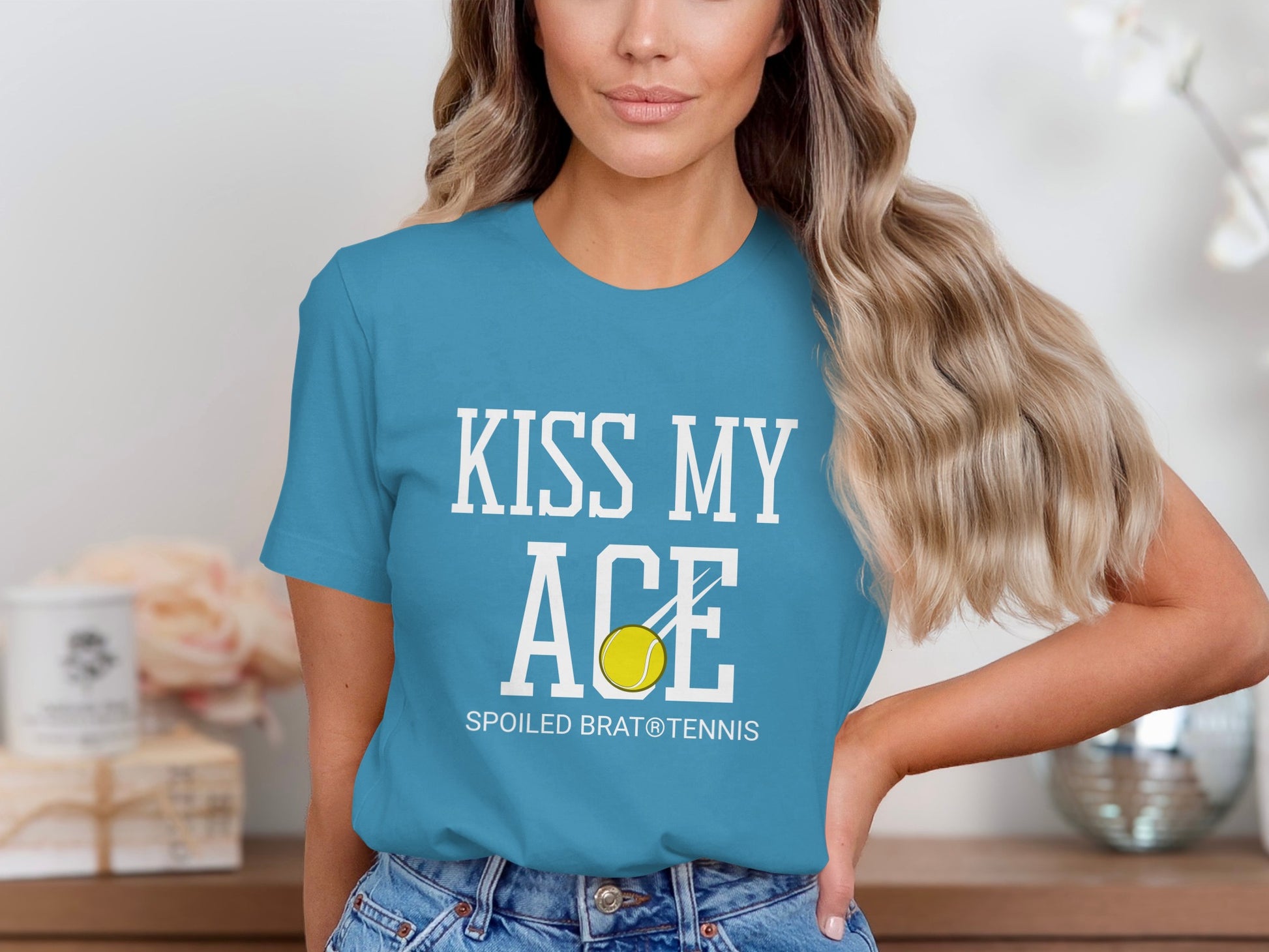 Blue t-shirt with white text "KISS MY ACE SPOILED BRAT® TENNIS" and a tennis ball.