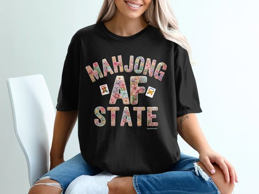 Black t-shirt with "Mahjong AF STATE" floral graphic and mahjong tiles.