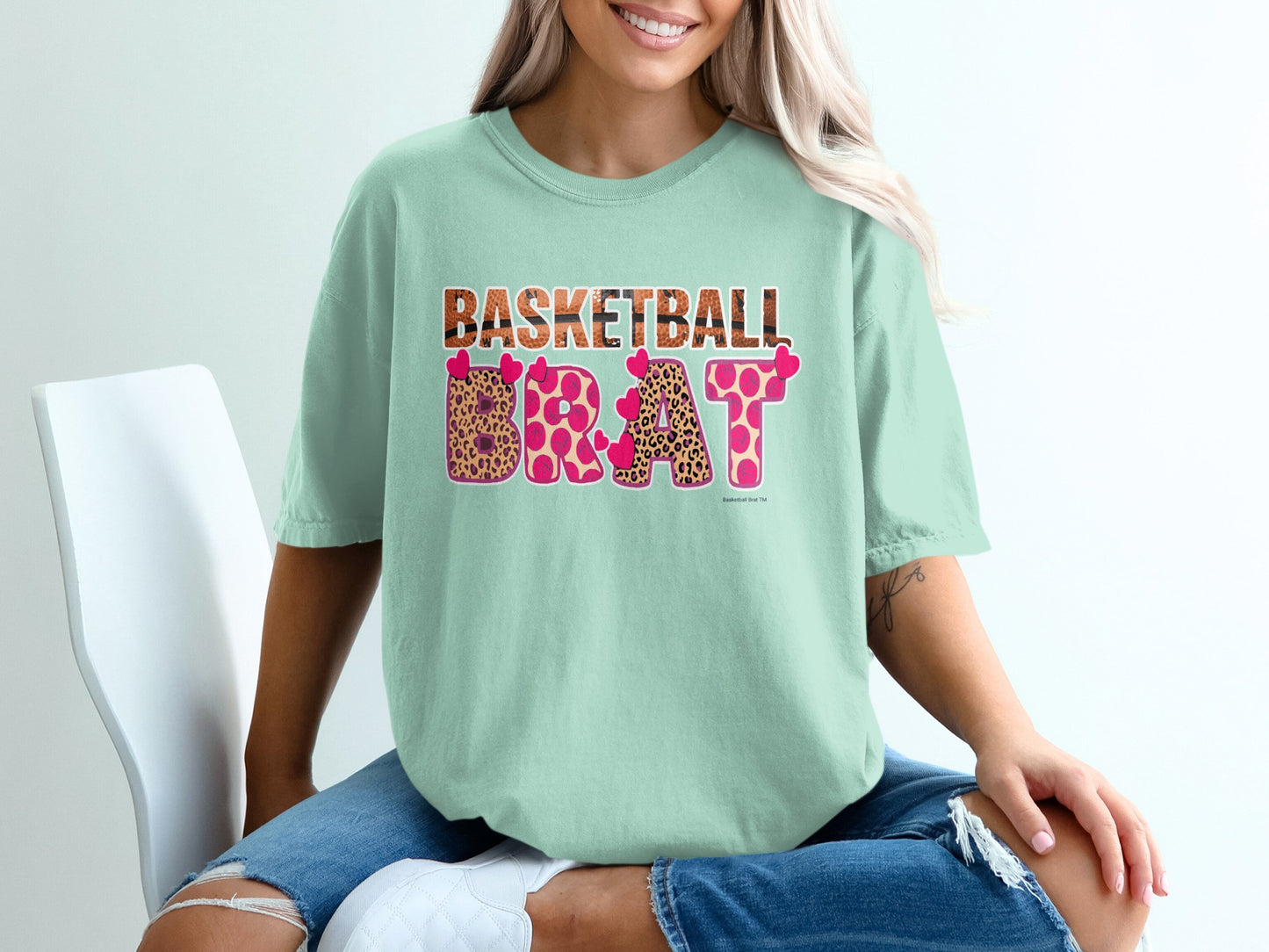 Mint t-shirt with "BASKETBALL BRAT" in pink leopard print and hearts.