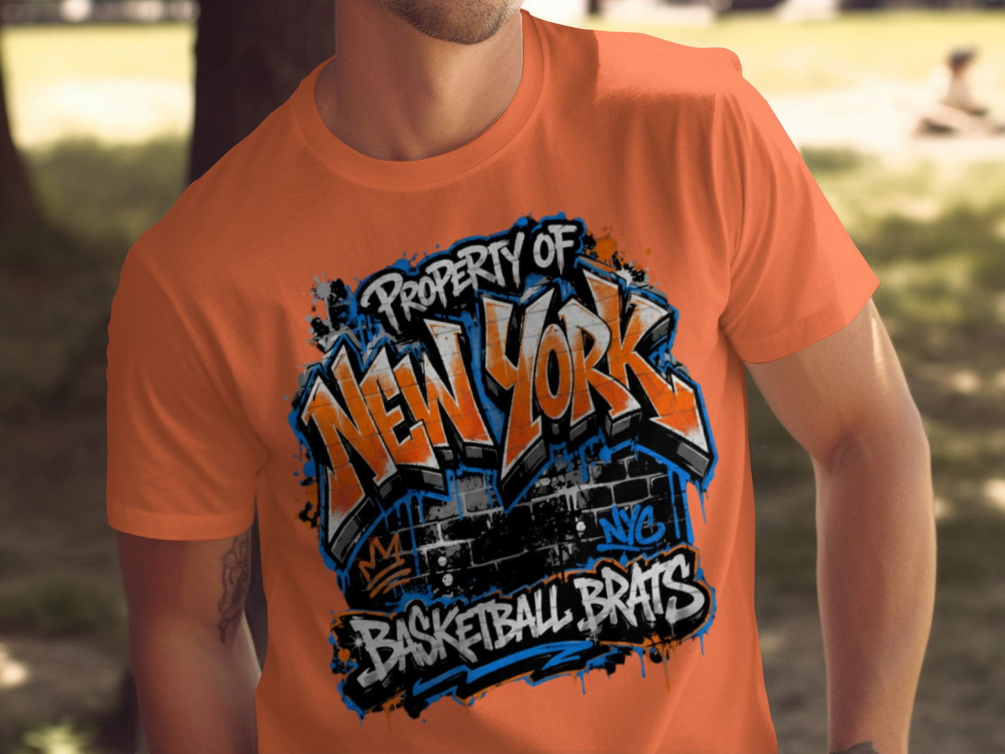 Orange t-shirt with graffiti-style "New York Basketball Brats" text and New York City logo.