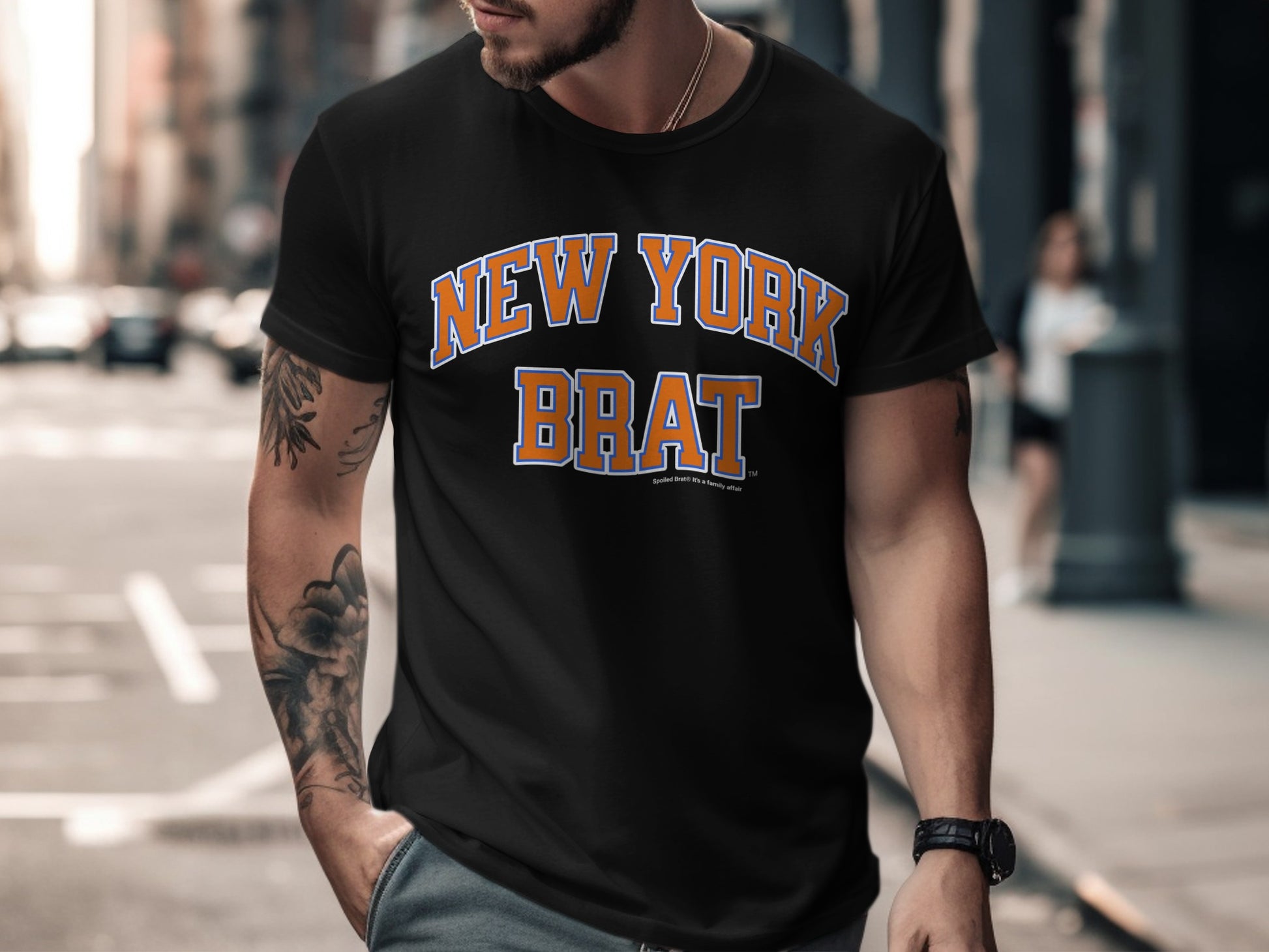Black t-shirt with "NEW YORK BRAT" in orange and blue lettering.