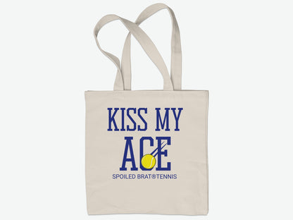 Beige canvas tote bag with "Kiss My Ace" text and tennis ball graphic.