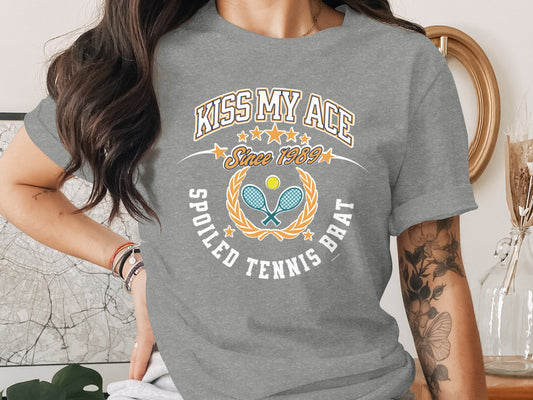 Grey t-shirt with "Kiss My Ace" and tennis racket graphic.