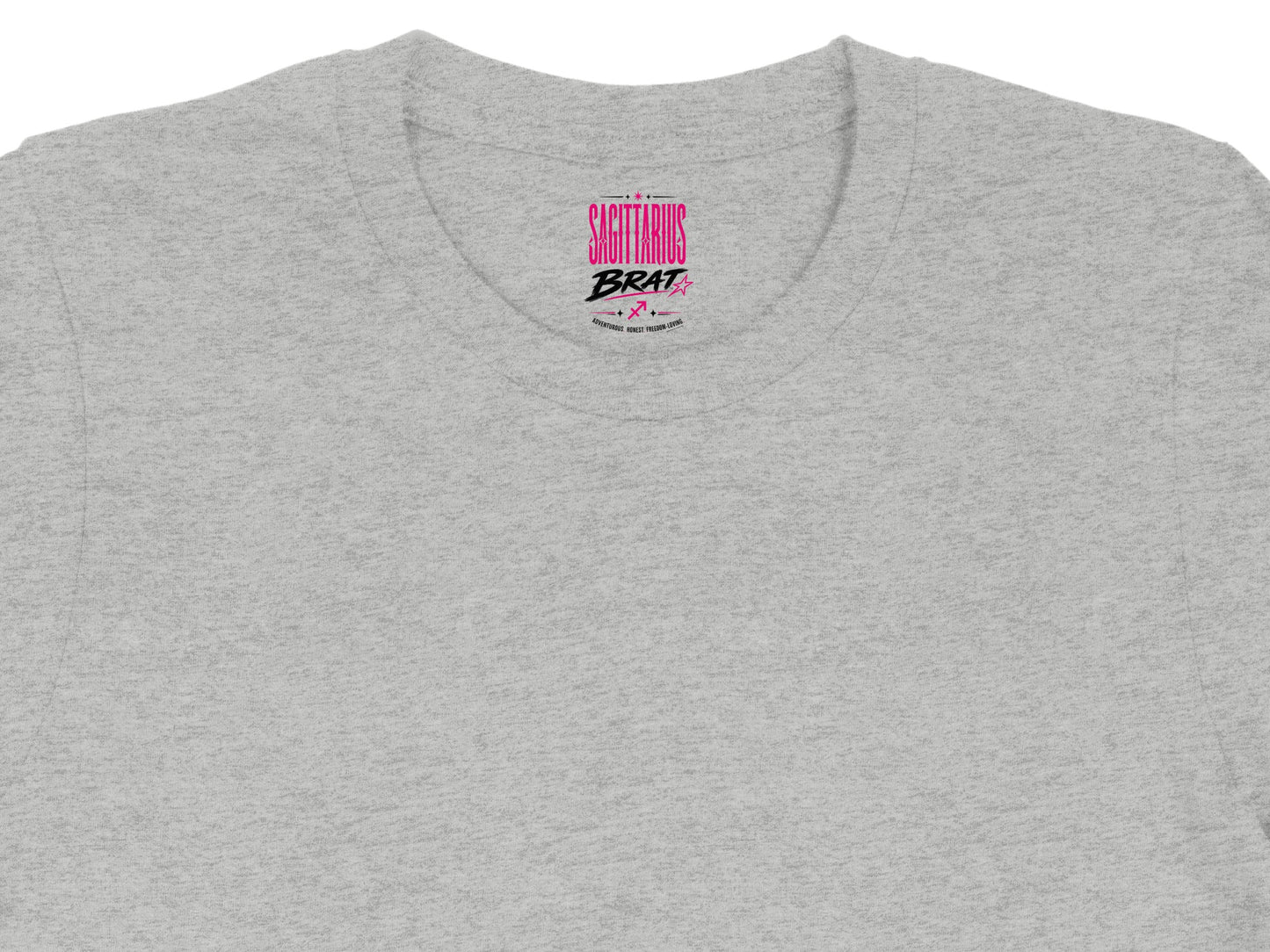 Grey crewneck t-shirt with "Sagittarius Brat" pink text and zodiac symbols.