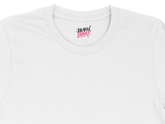 White t-shirt with "TRAVEL BRAT" logo on the neck label.