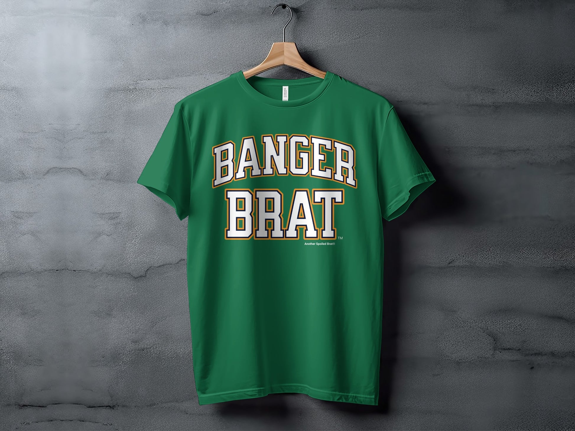 Green t-shirt with white and gold text that reads "BANGAR BRAT" and "Another Spoiled Brat®"