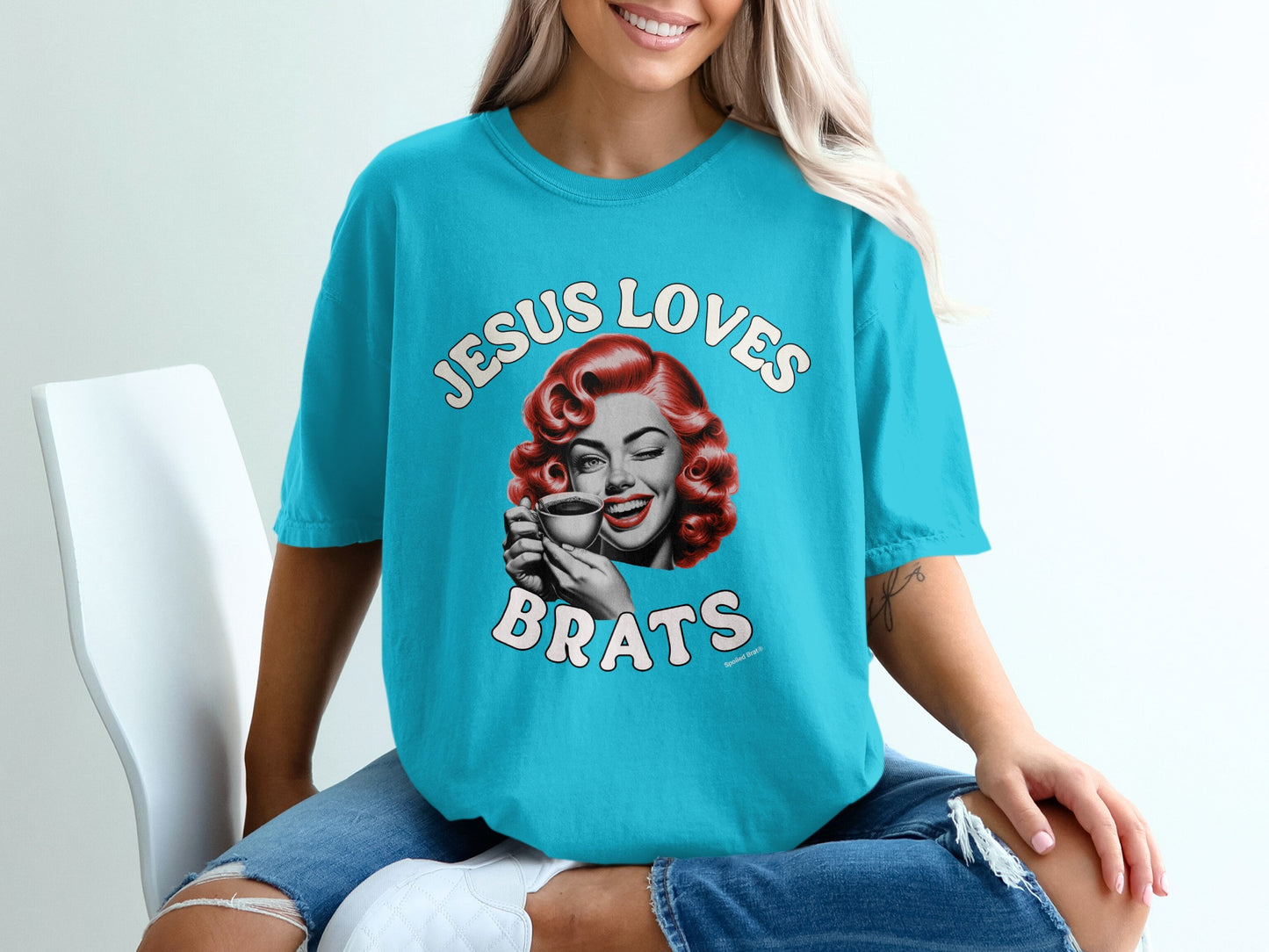Blue t-shirt with a vintage illustration of a woman winking and holding coffee.