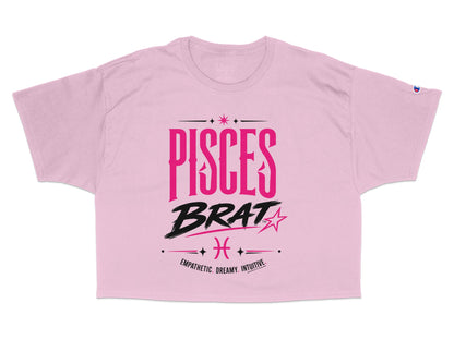 Pink cropped t-shirt with "PISCES BRAT" and Pisces zodiac symbol.