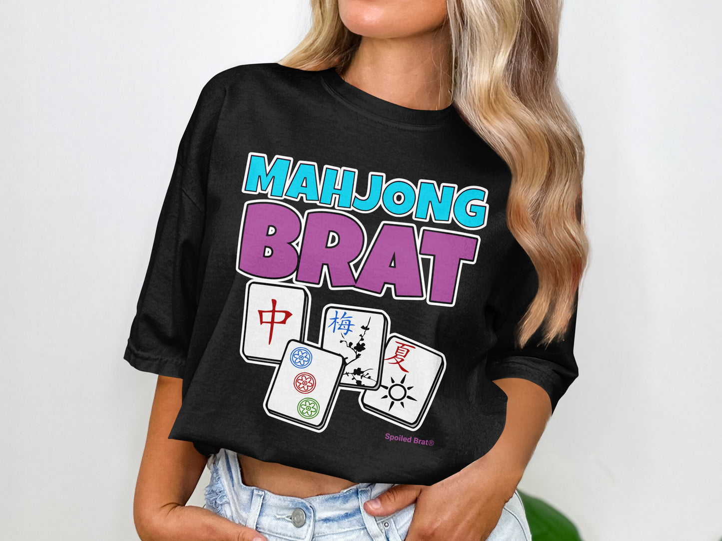 Black t-shirt with "Mahjong Brat" text and four mahjong tiles.