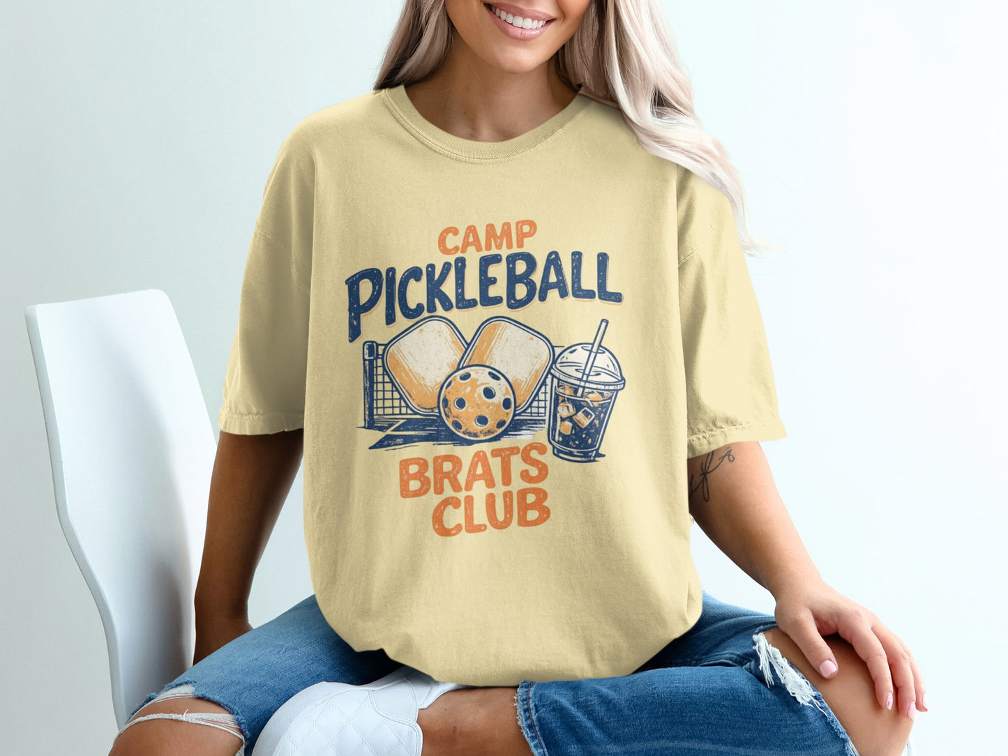 Camp Pickleball Brats Club graphic tee with pickleballs, net, and drink.