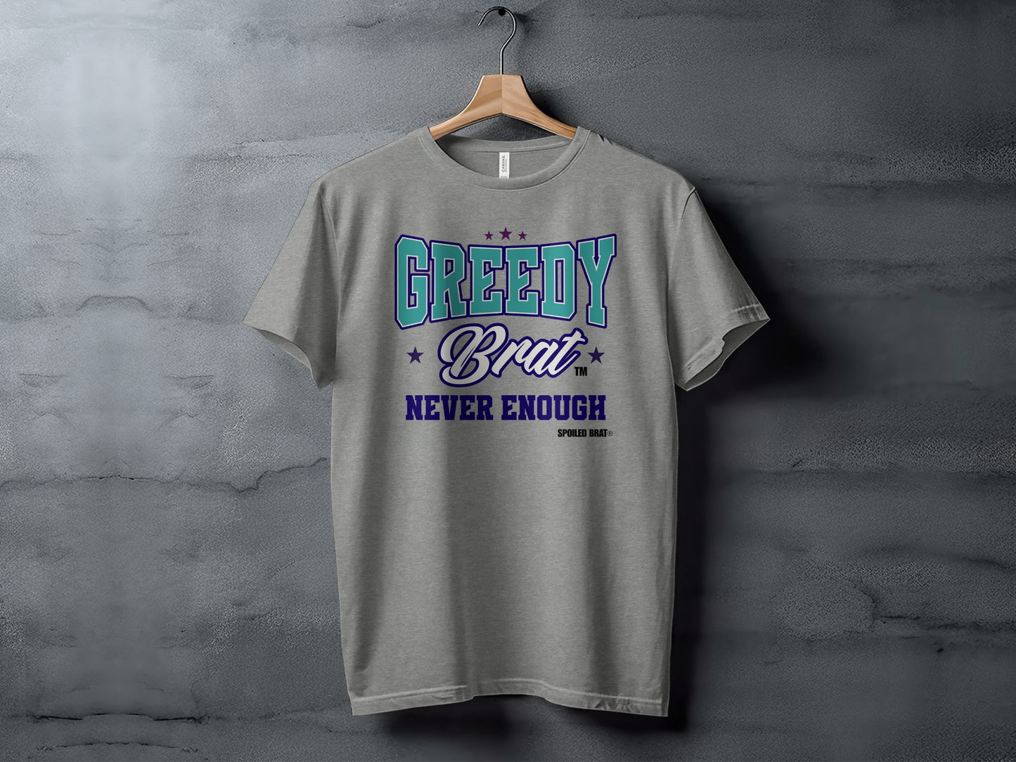 Grey t-shirt with "GREEDY Brat NEVER ENOUGH" text in teal and purple.