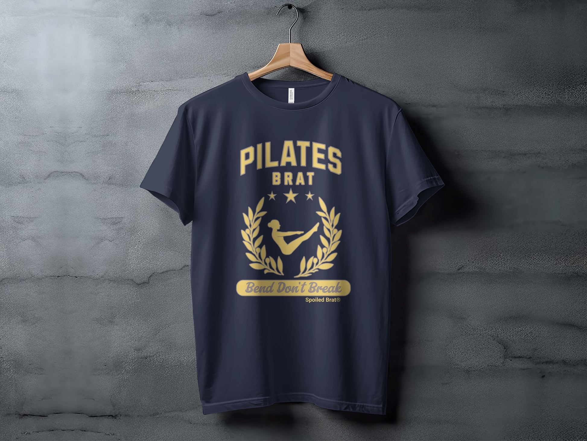 Dark navy t-shirt with gold "PILATES BRAT Bend Don't Break" graphic.