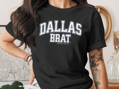 Black t-shirt with white "Dallas Brat" text and a smaller "Spoiled Brat: It's a family affair" below.